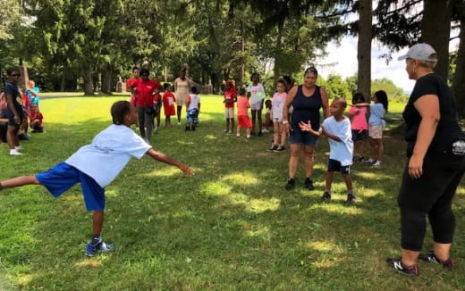 a group of people playing in a park