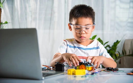 a boy using a laptop