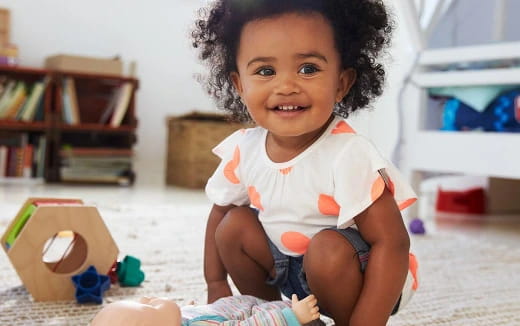 a baby sitting on the floor