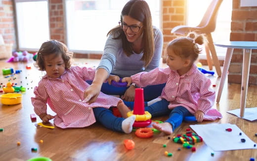 a person and two children sitting on the floor