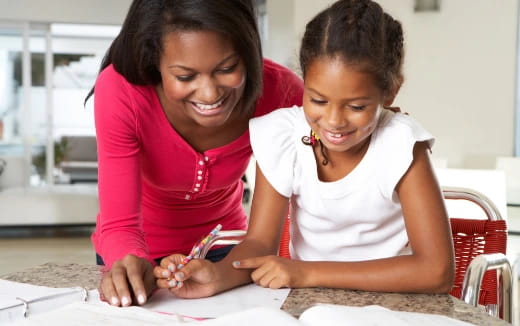 a person and a child looking at a paper