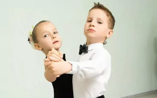 a boy and girl posing for a picture