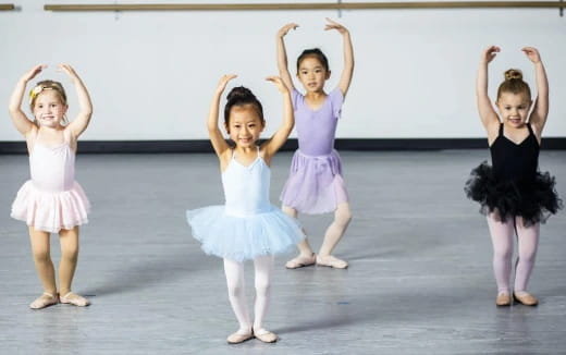 a group of girls in dresses