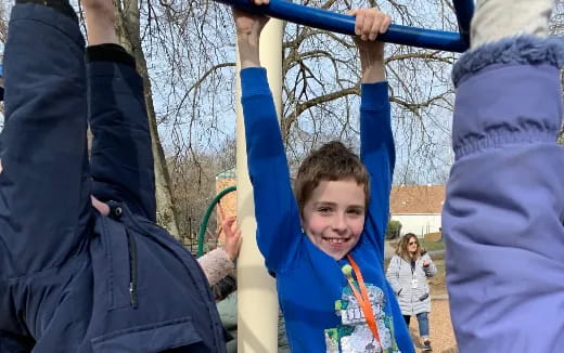 a boy holding a blue pole
