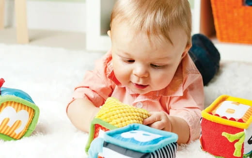 a baby playing with toys