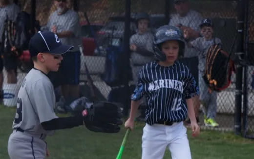 kids playing baseball on a field