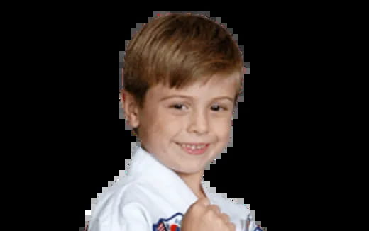 a boy smiling with a black background