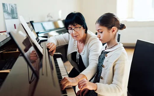 a few women playing piano