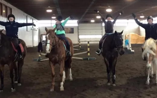 a group of people riding horses