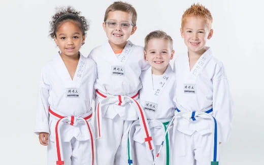 a group of kids wearing white karate uniforms
