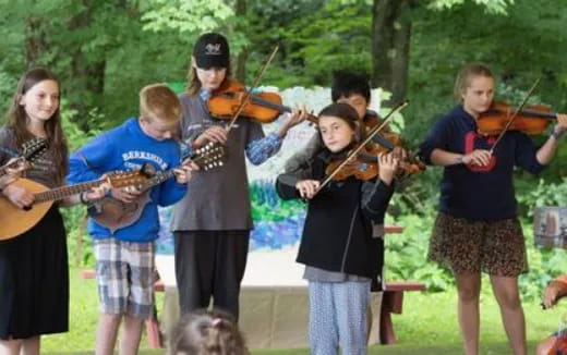 a group of kids playing instruments