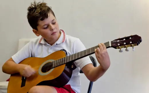 a boy playing a guitar