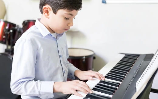 a boy playing a piano