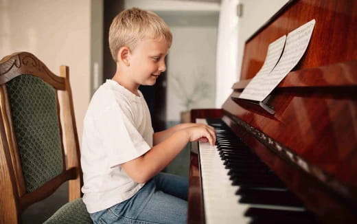 a boy playing a piano