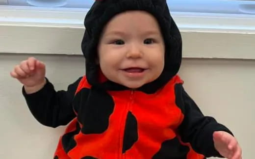 a baby wearing a black hoodie