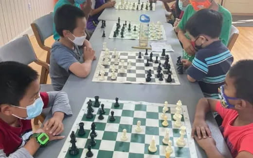 a group of children playing chess