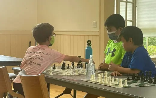 a group of kids playing chess