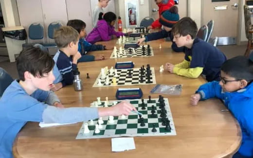 a group of people playing chess