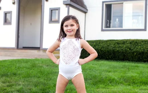 a girl standing in a yard