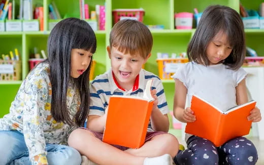 a group of children reading books