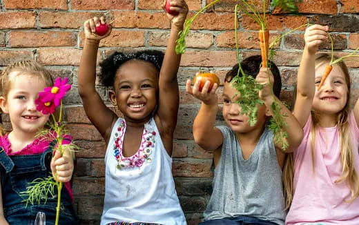 a group of children holding flowers