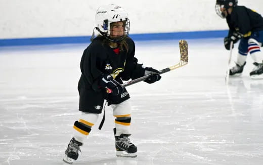 a hockey player in a black uniform
