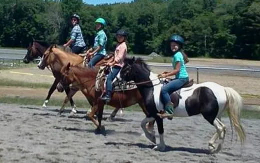 a group of people riding horses