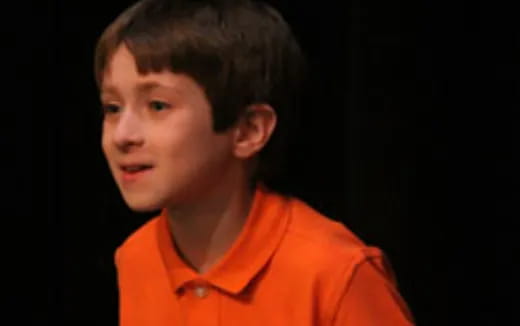 a boy in an orange shirt