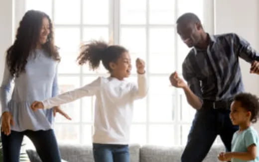 a family dancing in a room