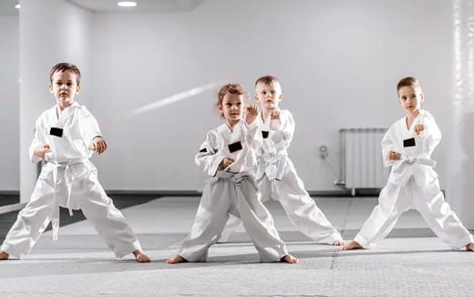 a group of people in karate uniforms