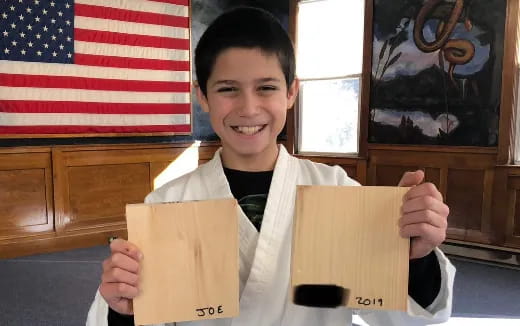 a boy holding a piece of paper