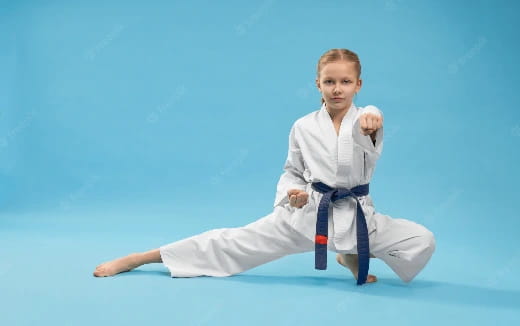 a young girl in a karate uniform