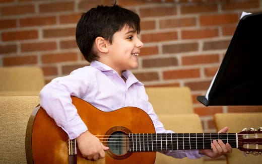 a boy playing a guitar