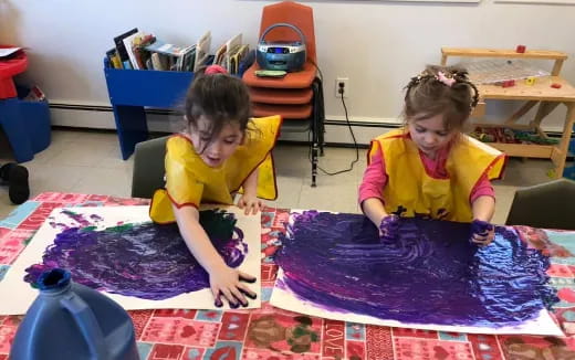 a couple of children playing on a rug in a room
