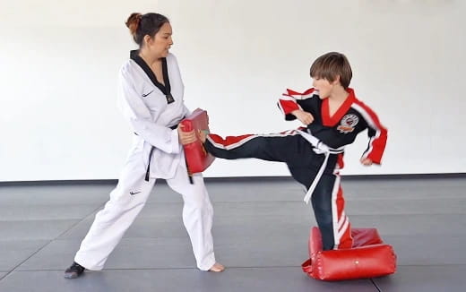 a person and a boy in karate uniforms