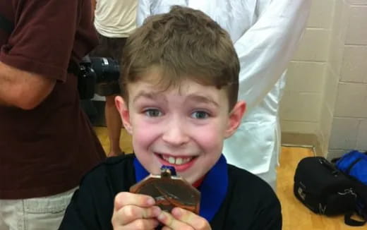 a boy eating a chocolate cake