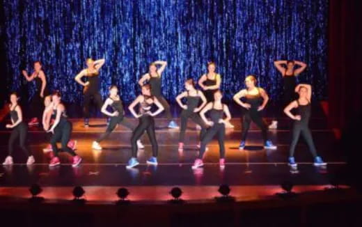 a group of people dancing on a stage