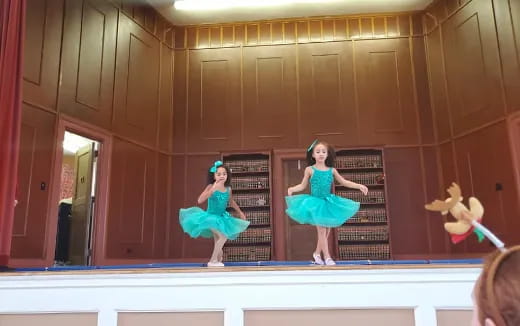 a group of girls dancing on a stage