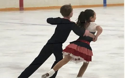 a man and woman ice skating