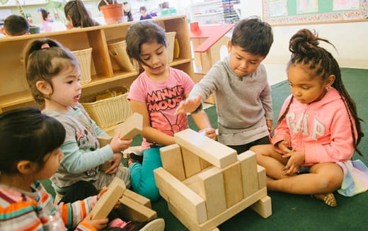 a group of children playing with blocks