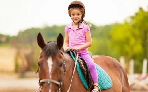 a girl riding a horse