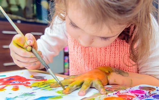 a girl cutting a fruit
