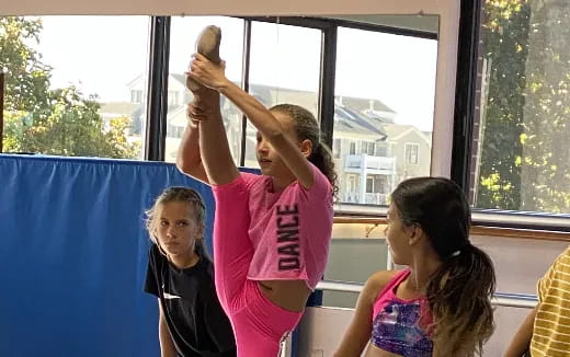 a group of girls looking at a phone