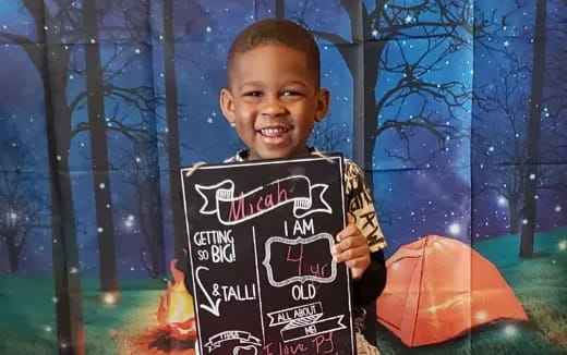 a boy holding a book