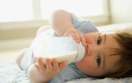 a baby with a bottle