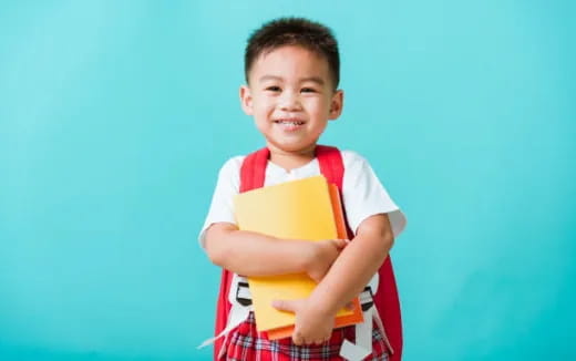 a boy holding a book