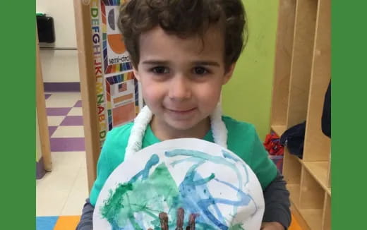 a boy holding a book