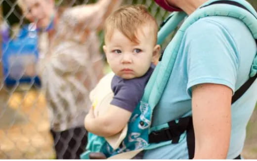 a child holding a baby