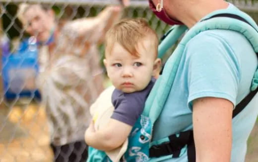 a boy holding a baby