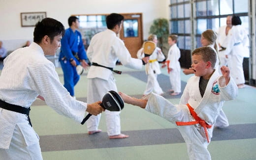 a group of people in karate uniforms